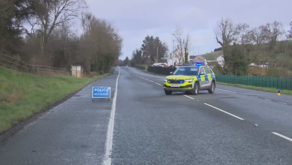 a police car and a road closure sign are seen on a road