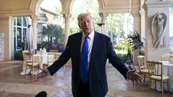 Donald Trump gestures as he speaks to reporters and members of the media at Mar-a-Lago