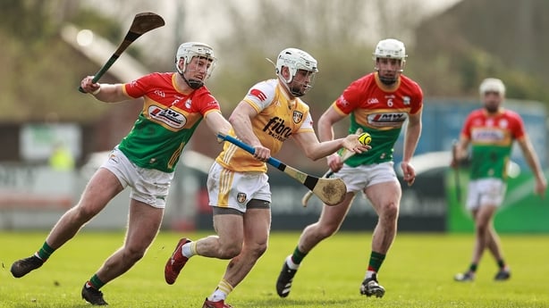 22 February 2026; Conor Johnston of Antrim in action against Carlow players Fiachra Fitzpatrick, left, and Kevin McDonald during the Allianz Hurling League Division 1A match between Antrim and Carlow at Corrigan Park in Belfast. Photo by Thomas Flinkow/Sportsfile