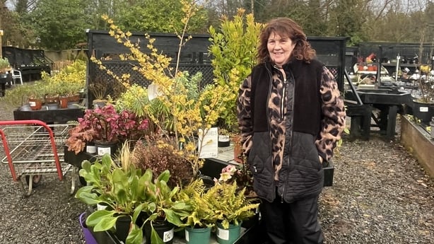 Aileen Muldoon Byrne stands next to plants