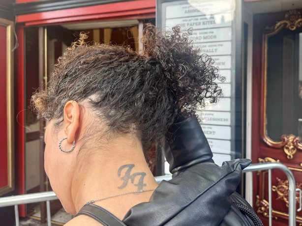 Andrea Felix showing their tattoo of Foo Fighters in a line outside 3Olympia Theatre, Dublin, to buy tickets to a surprise gig by the band. Picture date: Sunday February 22, 2026. PA Photo. Photo credit should read: Bairbre Holmes/PA Wire