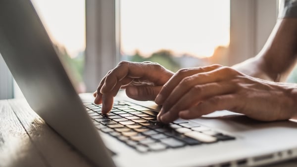 Man is typing on laptop computer keyboard