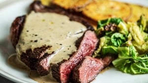 Steak with Peppercorn Sauce and Rustic Potato Slices show image