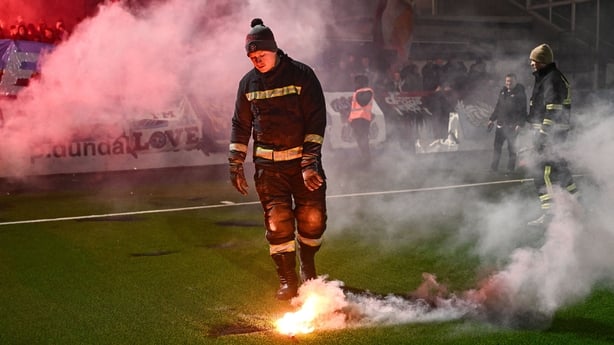 Fire stewards remove flares from the pitch before the SSE Airtricity Men's Premier Division match between Dundalk and Drogheda United at Oriel Park in Dundalk, Louth.