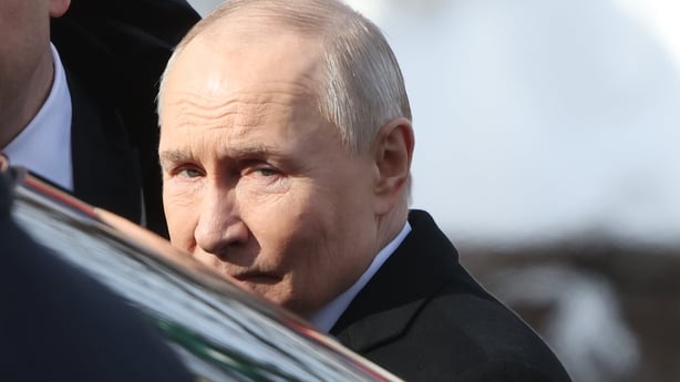 Russian President Vladimir Putin seen looking over a car 