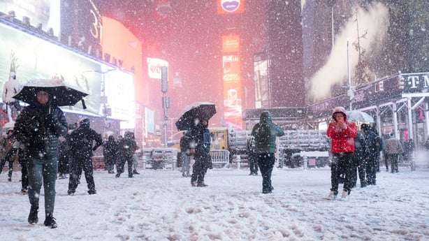 People walk in the snow in Times Square in New York City