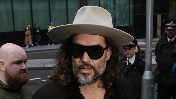 Russell Brand (centre) outside Southwark Crown Court, London.