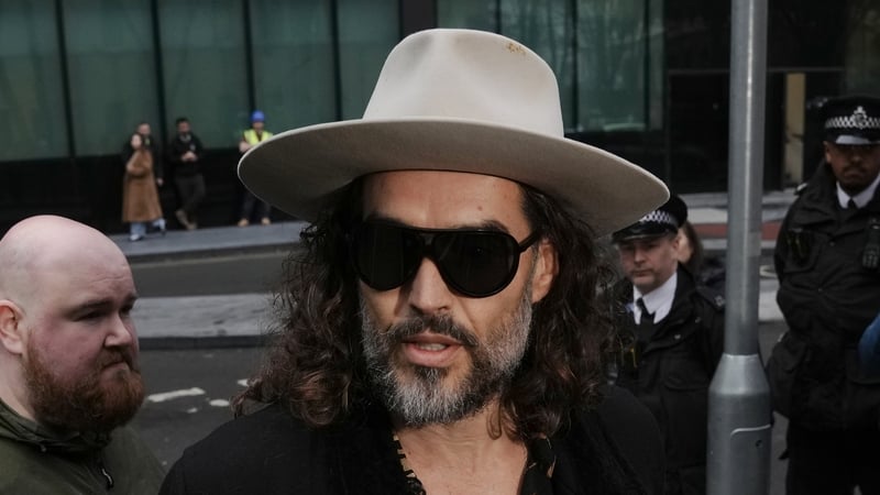 Russell Brand (centre) outside Southwark Crown Court, London.