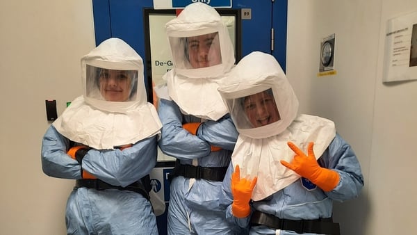 Students visit a laboratory at Viatris during Engineers Week wearing lab suits.