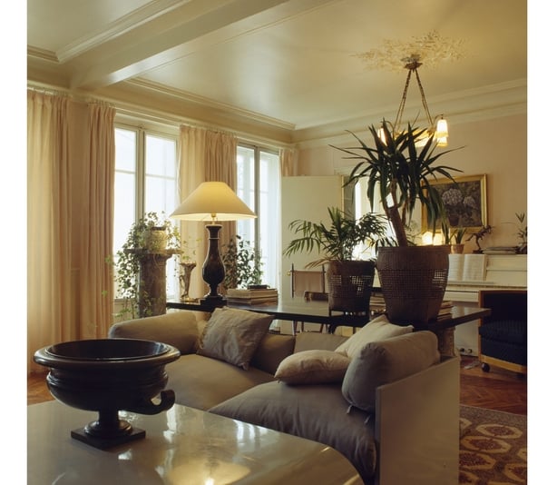  Lighted lamp and ceiling light in openplan cream living and dining room with beige sofa