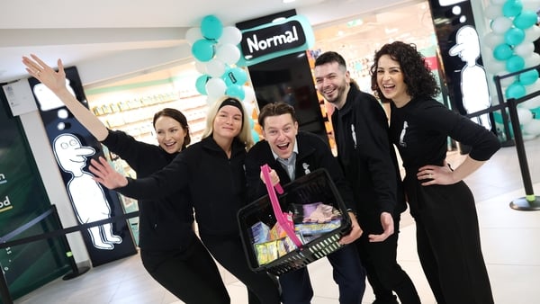 Excited staff holding a basket of goods outside a new Normal store in Dublin