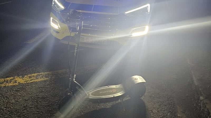 Picture of an e-scooter in front of a garda car