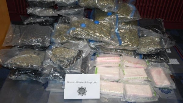 bags of cocaine and cannabis are displayed on a table