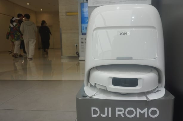 A DJI robotic vacuum cleaner ROMO showcased in a shop