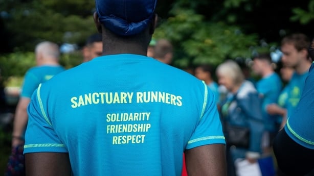 The back of a man's T-Shirt with Sanctuary Runners written on it