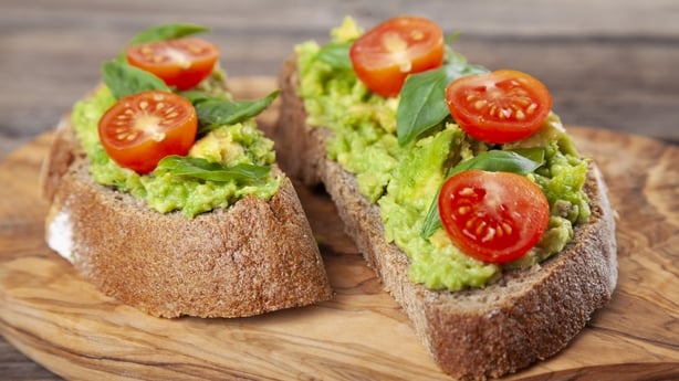 Healthy avocado sandwich, toast bread. Mushed avocado paste, on wooden background.