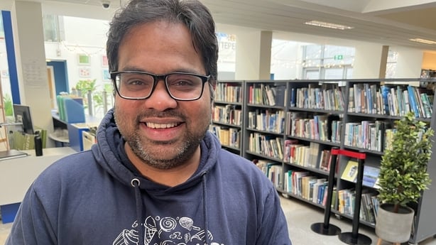 Mithun Pillai stands in Tallaght library