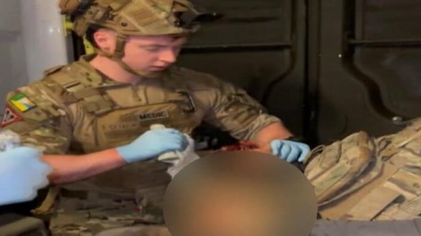 Oran McInerney conducting medical work on an injured individual in Ukraine