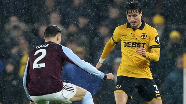 WOLVERHAMPTON, ENGLAND - FEBRUARY 27: Hugo Bueno of Wolverhampton Wanderers on the ball whilst under pressure from Matty Cash of Aston Villa during the Premier League match between Wolverhampton Wanderers and Aston Villa at Molineux on February 27, 2026 i