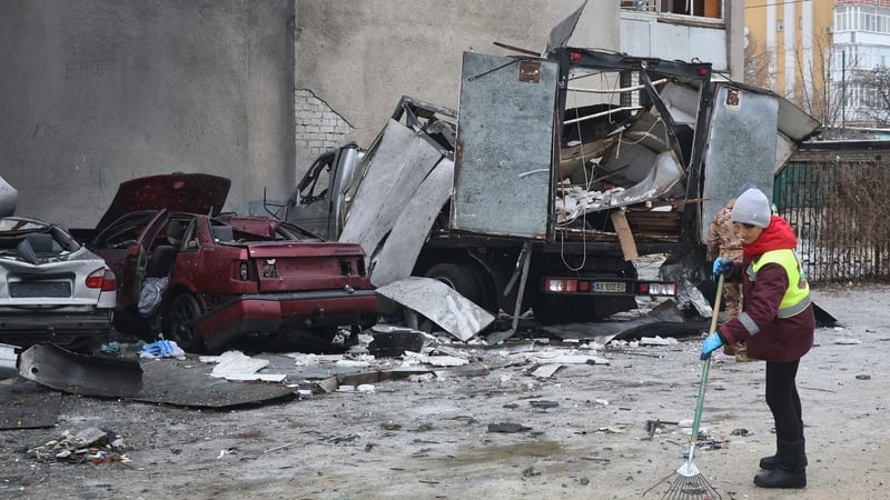 A female utility worker operates at the scene of a Russian strike drone hit on a residential high-rise in Kharkiv, Ukraine