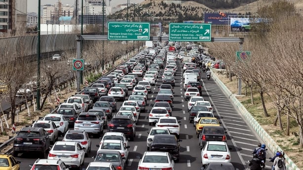 Motorists make their way along a street in Tehran