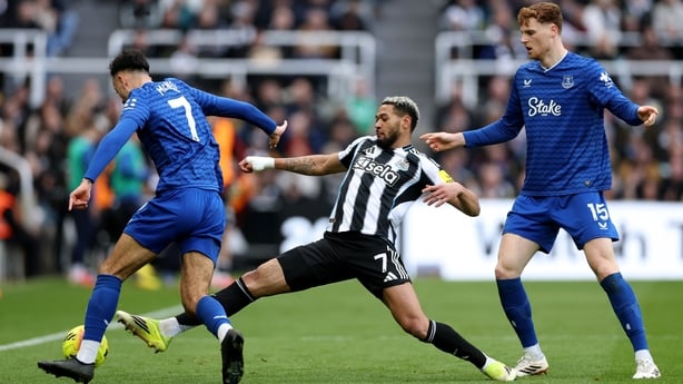 Joelinton of Newcastle United challenges for the ball under pressure from Dwight McNeil and Jake O'Brien of Everton during the Premier League match between Newcastle United and Everton at St James' Park on February 28, 2026 in Newcastle upon Tyne, England.