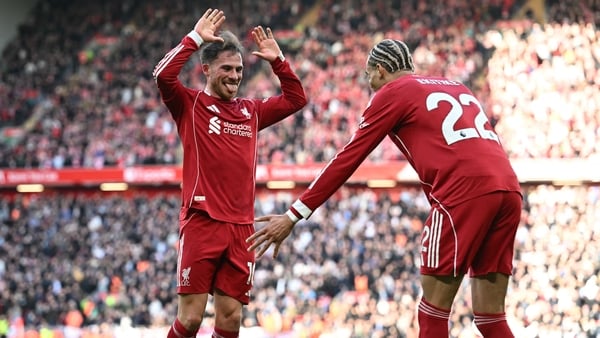 Alexis Mac Allister celebrates with Liverpool's French striker #22 Hugo Ekitike after scoring their third