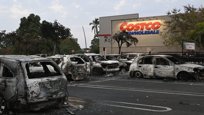 Burned cars are seen in the parking lot of a Costco retail store in Puerto Vallarta, Jalisco state