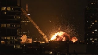 A fireball lights the sky following a missile strike on Tel Aviv on February 28, 2026.