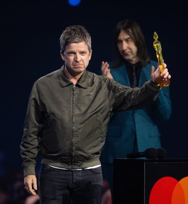 Noel Gallagher receives the award for songwriter of the year from Bobby Gillespie during The BRIT Awards 2026