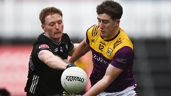 Jack Higgins of Wexford is tackled by Luke Casserly of Sligo during the Allianz Football League Roinn 3 match between Wexford and Sligo at Chadwick's Wexford Park in Wexford