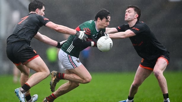 Sam Callinan of Mayo is tackled by Jarly Óg Burns, left, and Ross McQuillan of Armagh during the Allianz Football League Division 1 match between Mayo and Armagh at Hastings Insurance MacHale Park in Castlebar, Mayo. 
