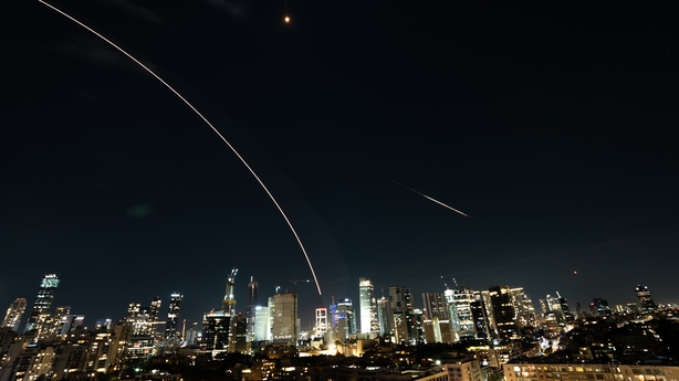 Intercepted missiles are seen in the night sky in Tel Aviv, Israel