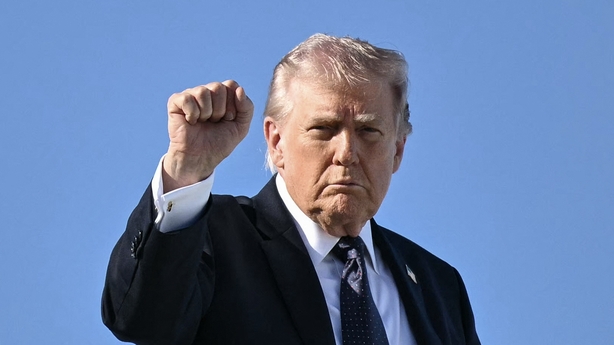 US President Donald Trump gestures as he boards Air Force One before departing Palm Beach International Airport in West Palm Beach, Florida, on March 1, 2026, on his way back to Washington, DC. The United States and Israel launched massive bombardments against Iran and killed its supreme leader on F