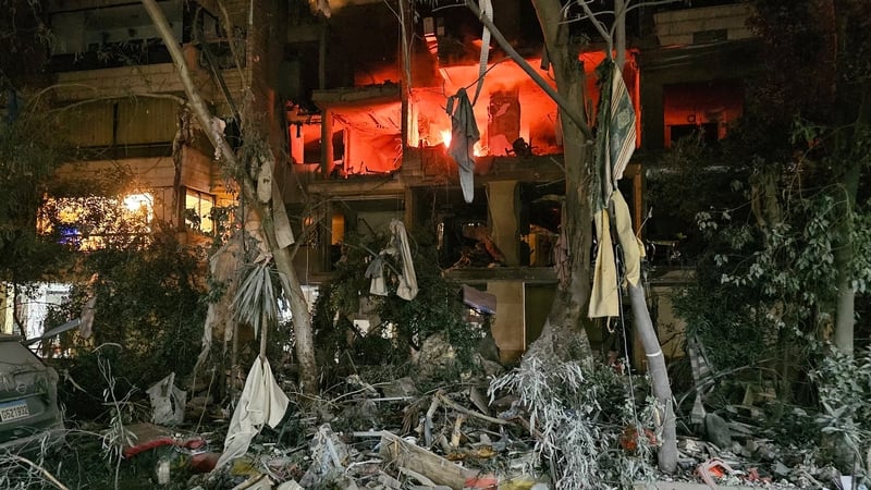 A fire is seen in a damaged building after an Israeli airstrike in Beirut
