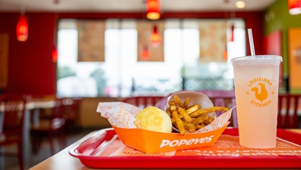 A fastfood meal with a drink on a tray in a restaurant