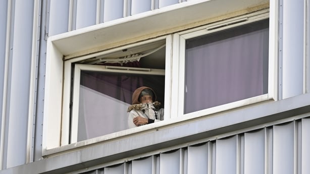 Pixelated image of person in window of a tower block in Calder, Edinburgh,
