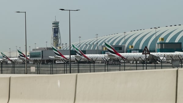 Emirates airline planes are parked on the tarmac at Dubai International Airport