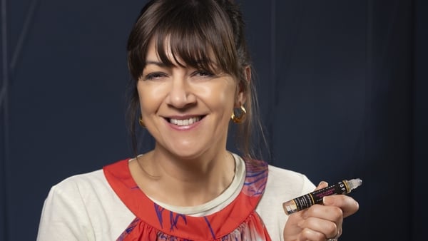 Woman posed for a photo with one of her products in her hands