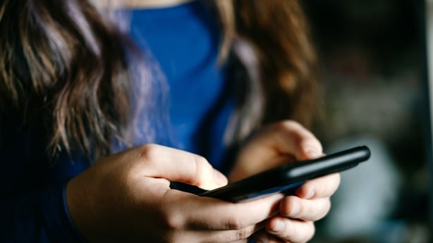 Young person holding a phone