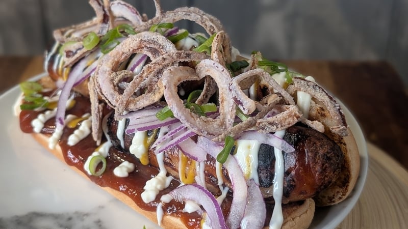 A hot dog loaded with toppings