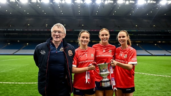 Kilkerrin-Clonberne players, from left, Niamh Divilly, Siobhán Divilly and Olivia Divilly celebrate with their father Michael - after winning 2025 All-Ireland senior club football title