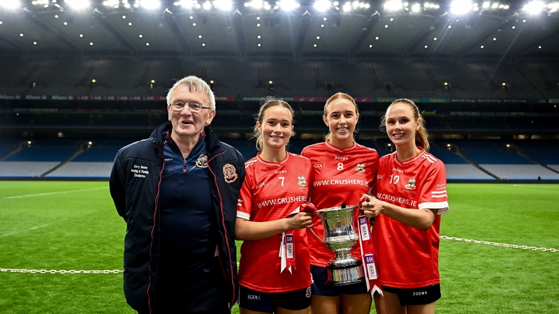 Kilkerrin-Clonberne players, from left, Niamh Divilly, Siobhán Divilly and Olivia Divilly celebrate with their father Michael - after winning 2025 All-Ireland senior club football title