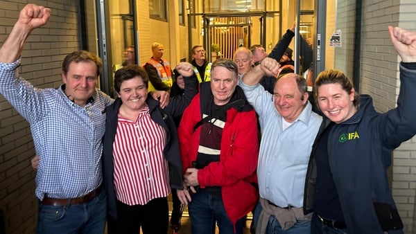 Five IFA members who staged a sit-in protest inside the reception area of the building cheer outside the office