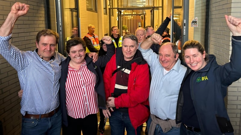 Five IFA members who staged a sit-in protest inside the reception area of the building cheer outside the office