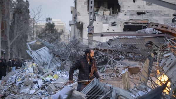 An Iranian man works on the ruins of a police headquarters that is completely destroyed in US-Israeli attacks in Tehran