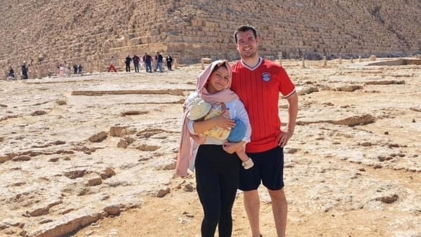 Jake McAllister and his wife, holding their baby