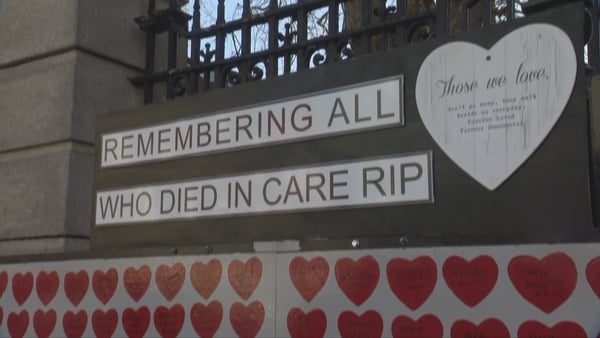 A memorial wall reads "remembering all who died in care"