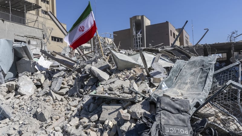 An Iranian flag is planted in the rubble of a police station, damaged in airstrikes yesterday, on March 3, 2026 in Tehran, Iran.