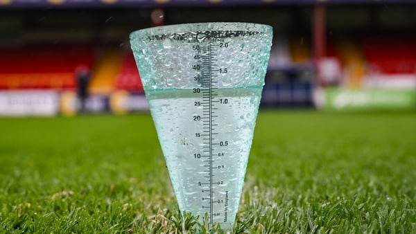 A rain guage on a pitch during a pitch inspection